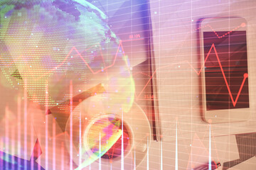 Multi exposure of forex graph hologram over desktop with phone. Top view. Mobile trade platform concept.