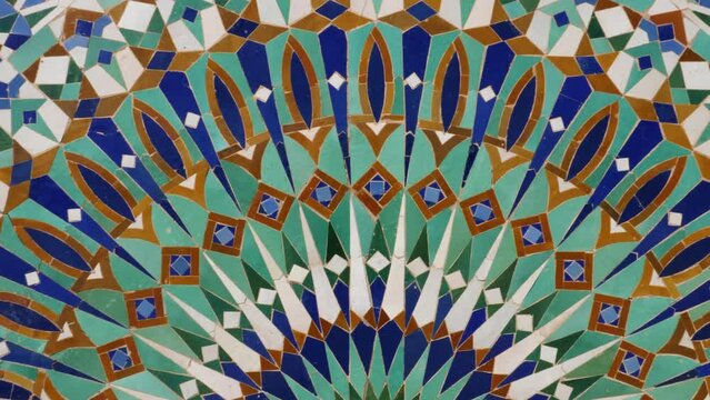 Colorful zellige tiles of a fountain in Morocco. Mosaic pattern,  traditional Islamic geometric design. Moroccan craft, handmade. 4k footage.