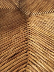 Fototapeta premium Textured woven straw background in a chair seat