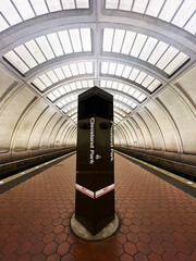 The Cleveland Park Metro Station platform tunnel, with no people visible, in Washington, DC. The station is part of the Washington metro area transit authority system (WMATA)