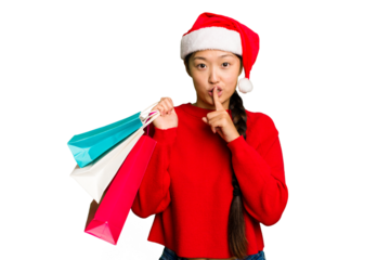 Young asian woman shopping a christmas presents isolated Young asian woman shopping a christmas presents isolated keeping a secret or asking for silence.