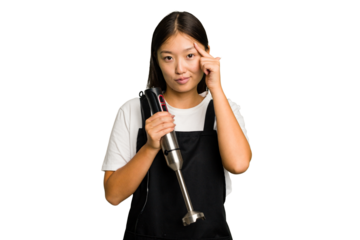 Young asian cook woman holding a blender isolated pointing temple with finger, thinking, focused on a task.
