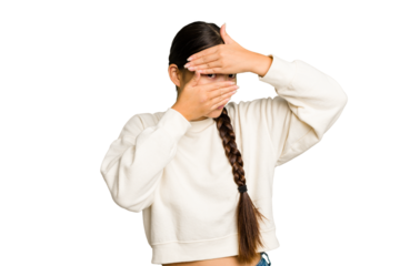 Young Asian woman isolated blink at the camera through fingers, embarrassed covering face.