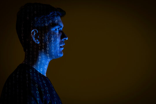 Close-up of a man with binary code reflected on his face