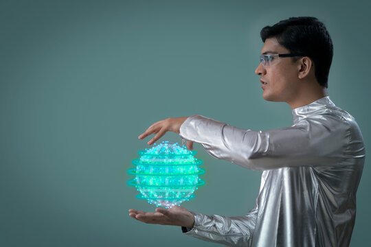 A man wearing silver, futuristic  clothes holding digital globe , future technology concept