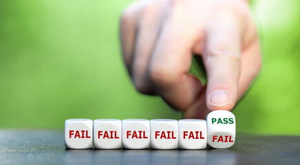 Symbol for never giving up. Hand turns dice and changes the word fail to pass.