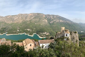 Fototapeta na wymiar Panoramic view of the Castle of Guadalest, in Alicante, Spain. An old medieval town on top of a mountain. A large reservoir is in the background.