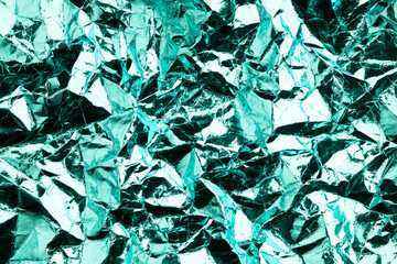 Color foil background with shiny crumpled surface for texture background. Abstract glossy background.