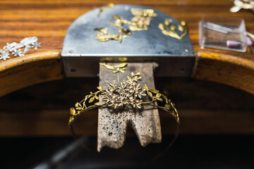 Golden tiara on workbench in workshop