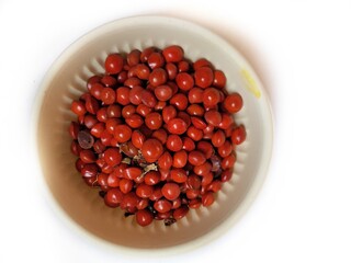 Red sandalwood or Red Lucky seeds or Ratangunja or  Adenanthera pavonina L.  Used as beads, in percussion instruments, also due to medicinal properties used as a medicine in Ayurveda, India.