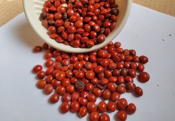 Red sandalwood or Red Lucky seeds or Ratangunja or  Adenanthera pavonina L.  Used as beads, in percussion instruments, also due to medicinal properties used as a medicine in Ayurveda, India.