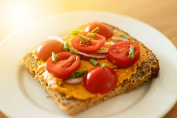 Fototapeta na wymiar Healthy sandwich with vegan cream and tomatoes