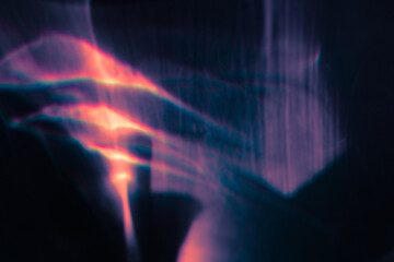 Blur colorful warm pink rainbow light leaks on black background. Defocused abstract analog retro film lens flare bokeh overlay or screen filter effect. Glow Vintage prism, water caustic, surreal light
