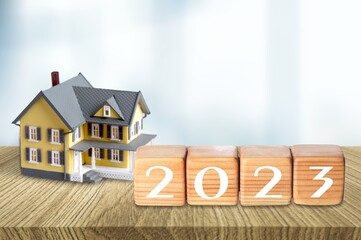 Small toy house and 2023 numbers on the desk