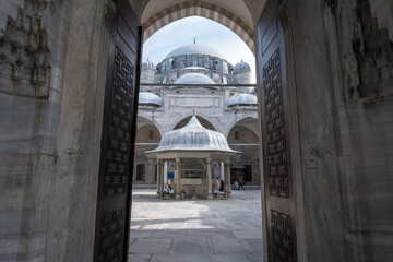 Exterior of The Sehzade Mosque known as Şehzade Paşa Camii, mosque view from the entrance, different perspective, ottoman historical artifacts, wooden door