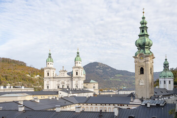 Fototapeta na wymiar Domes and towers of the Salzburg Cathedral, two spires on Domplatz Square, Baroque architecture; Austria, Salzburg,