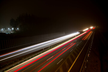 Fototapeta na wymiar Car light trails at night on a highway seen downwards, long exposure 