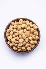 Glycine max or Soya bean or uncooked soybean chunks. Served in a bowl or as a Pile. selective focus