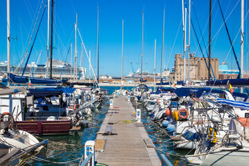 Marina bay with yachts, vessels, sailboats and other ships in Livorno, Italy. Sunny day with blue sky and sea water
 - obrazy, fototapety, plakaty