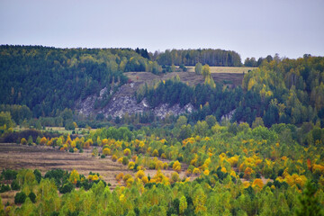 Autumn panorama of Mount Podkamennaya near the river Sylva