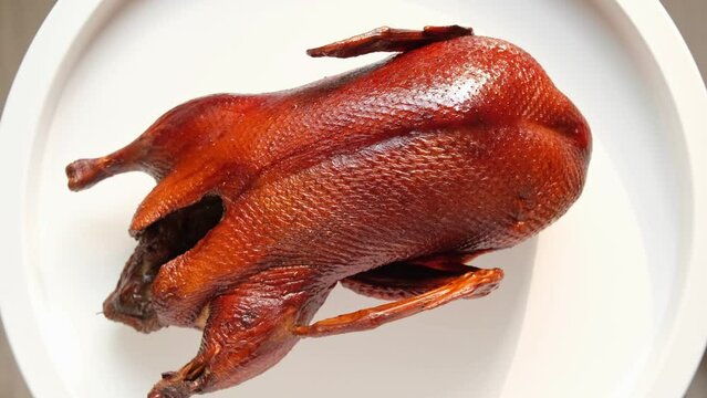 Whole smoked Duck Platter. Duck carcass on a cutting white Plate. Grilled wild Bird. Tradition Asian Food. Roasted Duck meat. Close Up. Gastronomy, Restaurant Meal. Traditional Christmas Food