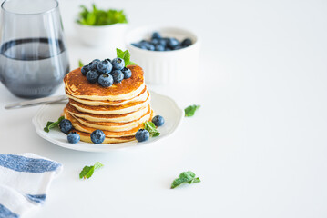 Homemade baked ricotta pancakes with fresh berries on white wooden table
