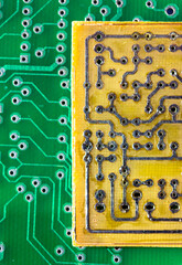 Printed green and yellow circuit boards. Electronic computer hardware technology macro. A digital motherboard chip. Microprocessor, transistors, semiconductor made from silicon. Technical science.