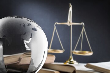 International Law concept. World globe and scales