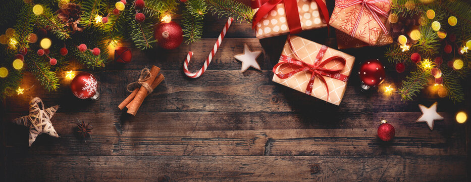 Christmas gift boxes with decorations on wooden background