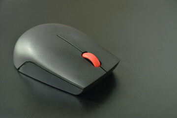 gray computer mouse on black laptop background 