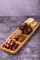 Mixed Turkish delight varieties on a dark background. Pistachio, hazelnut and fruit flavored Turkish delights. close up