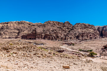 A view across the valley down the main thoroughfare towards the Royal Tombs in the ancient city of Petra, Jordan in summertime