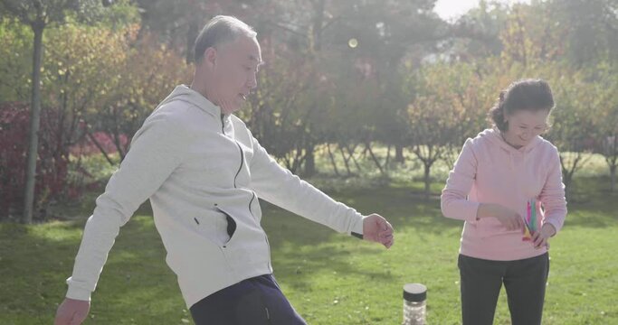 Cheerful senior Chinese adult relaxing in the park,4K