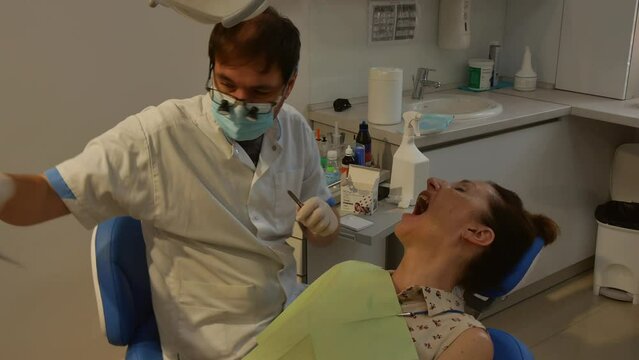 Dental clinic. Young adult woman at the dentist appointment.