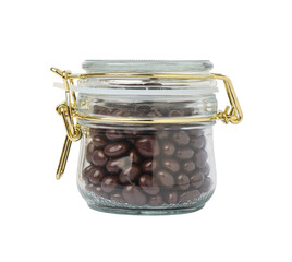 Closed glass jar with dragee chocolate-covered raisins, isolated on white background