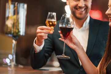 Sitting and drinking. Man and woman is together in the bar