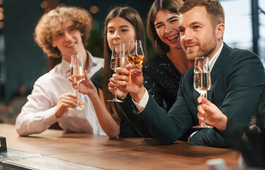 Friends are having fun. Group of people in elegant clothes are in the restaurant celebrating event