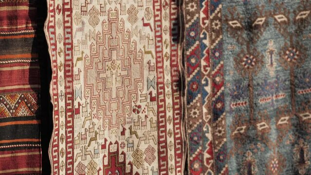 Details of traditional Turkish carpet in Istanbul shop, Turkey. Close up of Middle Eastern Arabian carpets in market store.