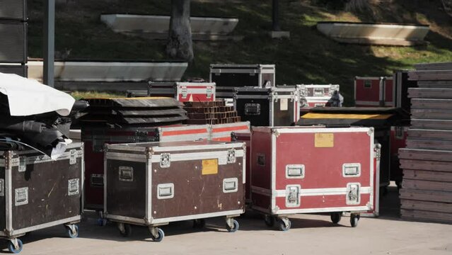 Sound engineering Installation of professional audio equipment for a live concert, backstage zone. Racks with stereo speakers amplifiers, subwoofer power distribution boxes with signal cables.