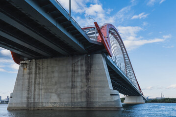 The large red arch bridge in summer close-up. Bottom view