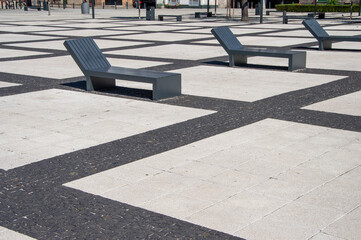 Wroclaw square lined with concrete elements and benches. Summer.