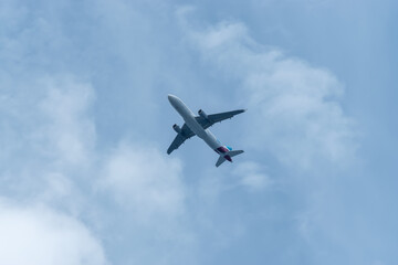 Fototapeta na wymiar Passenger Airplane take off on blue sky background.
