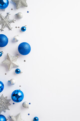 Christmas decorations concept. Top view vertical photo of blue white silver baubles snowflake star...