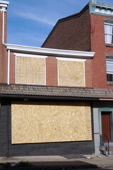 Boarded Up Brick Store Front and Blue Sky