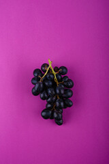 Red grape on purple violet background. Harvest concept