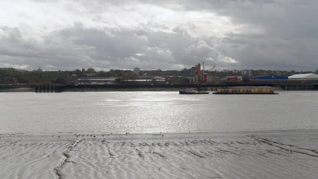 River Barge Transporting Cargo Along London's River Thames