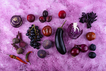 Assortment of purple vegetables on violet background