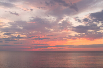 Naklejka na ściany i meble Calm sea with sunset sky with cloud.