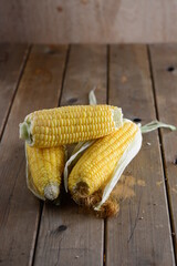corn on the cob on wooden background