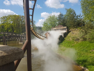 A roller coaster car entering a smoky tunnel at Efteling Amusement Park, Kaatsheuvel, Netherlands.